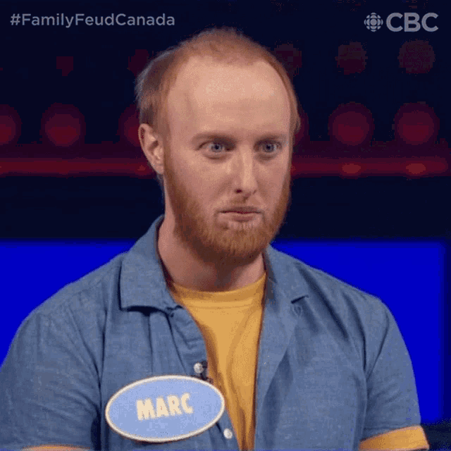 a man with a beard wears a name tag that says marc