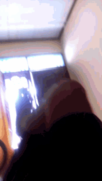 a blurry image of a person looking at a screen