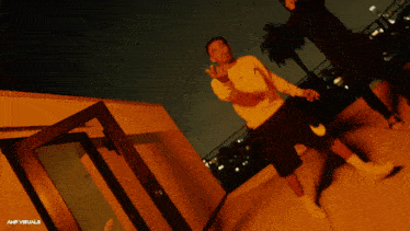 a man giving the middle finger in front of a door that says amp visuals on the bottom