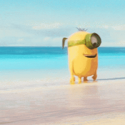 a yellow minion wearing green goggles and a starfish on his chest is standing on a beach