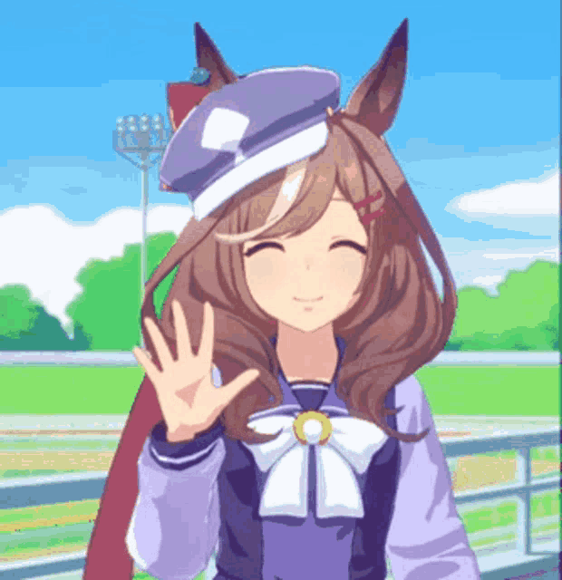 a girl with brown hair wearing a blue hat is smiling and waving her hand