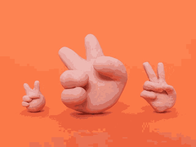 three clay hands on an orange background one giving the peace sign