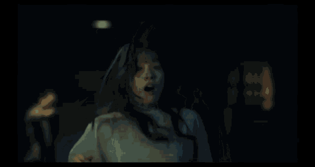 a woman with a surprised look on her face is running in the dark .