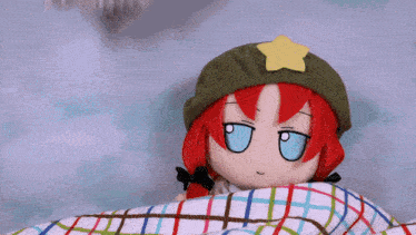 a stuffed doll wearing a green hat with a star on it