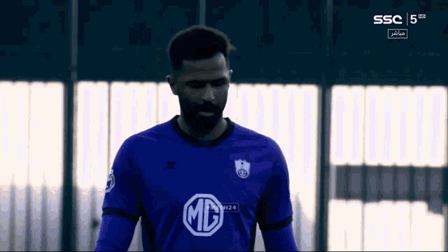 a soccer player wearing a purple shirt with a md logo