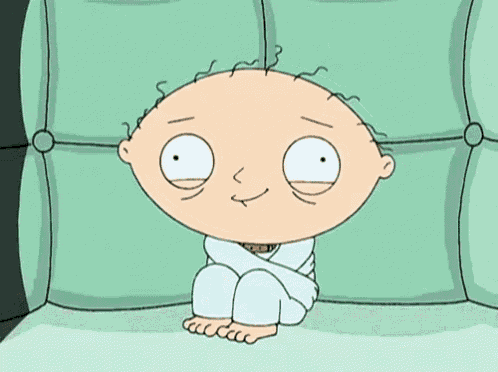 a cartoon character is sitting on a couch wrapped in a straitjacket