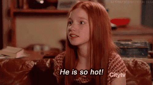 a young girl with red hair is sitting on a couch .