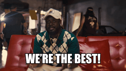 a man sitting on a red couch with the words " we 're the best " on the bottom