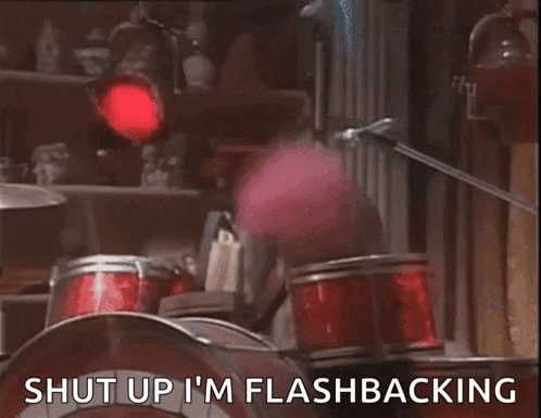 a person playing drums with the words " shut up i 'm flashbacking " written below them