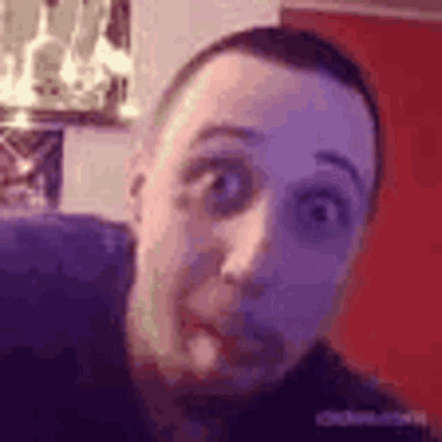 a close up of a man 's face making a funny face .