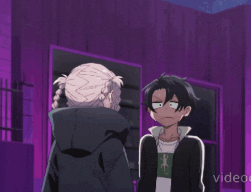 a man and a woman are standing next to each other in a purple room