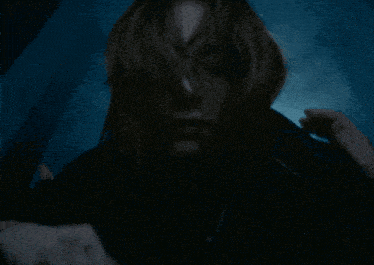 a close up of a person 's face with a dark background