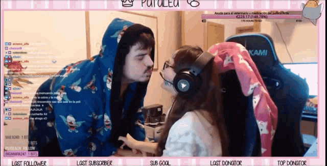 a man and a woman are kissing in front of a screen that says patalec