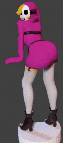 a statue of a woman in a pink dress with a mask on her face is standing on a pedestal .