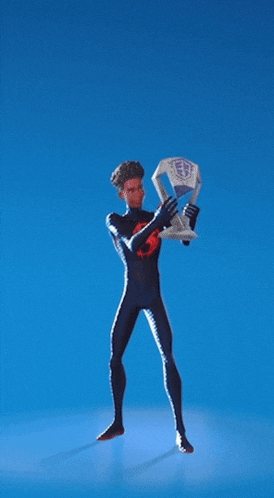 a man in a spiderman suit is holding a trophy above his head