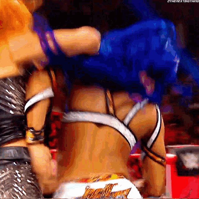a female wrestler is being knocked out by another wrestler