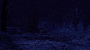 a person is holding a green light saber in the snow