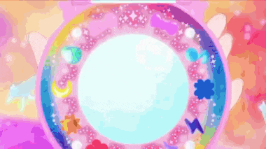 a person is holding a pink circle with a rainbow of decorations on it in their hand .