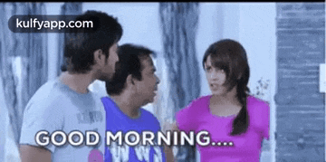 a group of people are standing next to each other in a room and one of them is saying good morning .