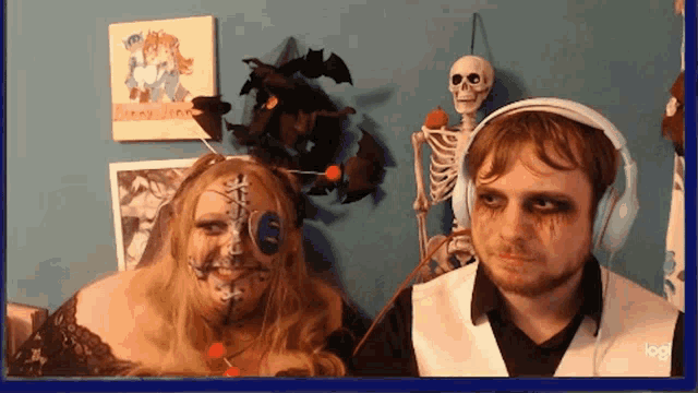 a man wearing headphones stands next to a woman with a skeleton in the background