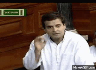 a man in a white shirt is waving his hand .
