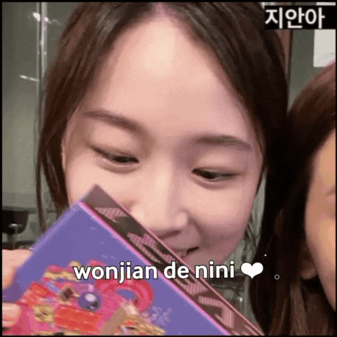 a woman is holding a book with wonjian de nini written on the bottom