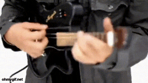 a man is playing a guitar with the website ohmygif.net in the bottom right corner