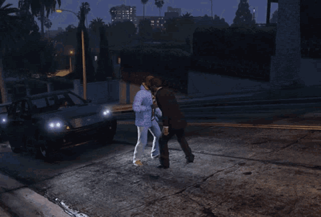 a man in a suit shakes hands with a woman in a blue jacket