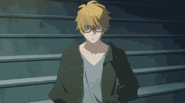 a man with yellow hair and glasses is pointing his finger at the camera