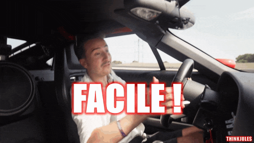 a man is sitting in a car with the word facile written on the screen