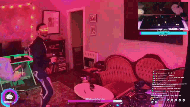 a man is dancing in a living room with gogotv written on the bottom of the screen