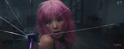 a woman with pink hair is behind a broken glass