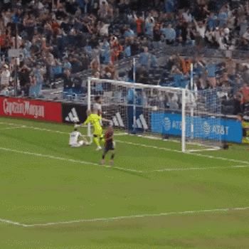 a soccer player is running in front of a sign that says sports