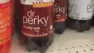 bottles of dr. perky soda are lined up on a counter