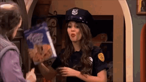 a woman dressed as a police officer is holding a box of cheerios
