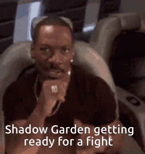 a man is sitting in a chair with the words shadow garden getting ready for a fight on the bottom
