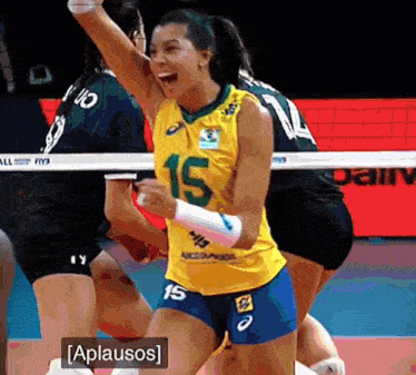 a female volleyball player wearing a yellow jersey with the number 15 on it