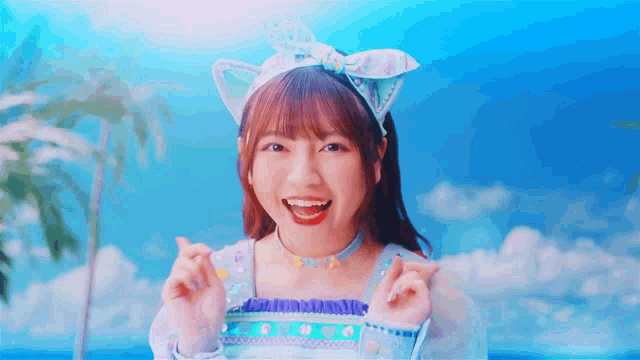 a girl wearing a cat ear headband and a choker is smiling