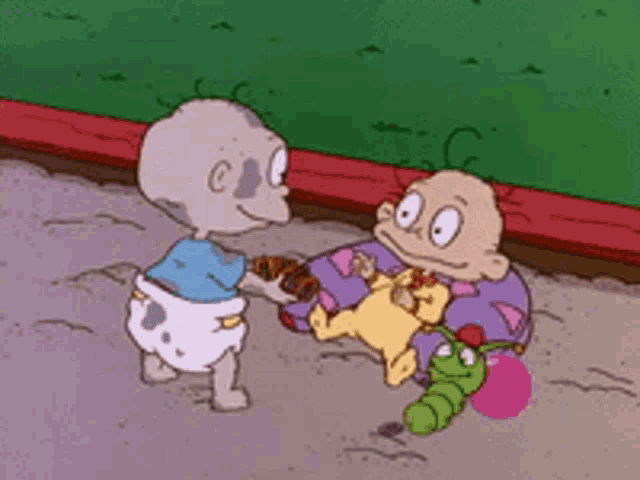 two babies from rugrats are playing with toys in a sandbox