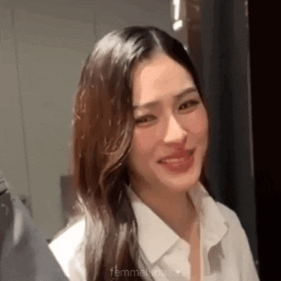 a close up of a woman wearing a white shirt smiling