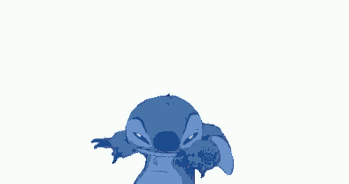 stitch from disney 's lilo and stitch is looking at the camera with his mouth open .