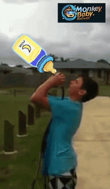 a boy is drinking milk from a bottle with monkey baby business written on the bottom