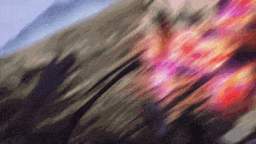 a blurry picture of a person 's face with a purple and red colored background