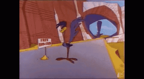 a cartoon character is standing on the side of a road next to a sign that says free tips and tricks .