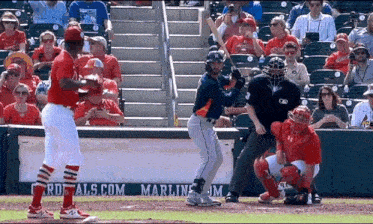a baseball game is being played in front of a banner that says marlins