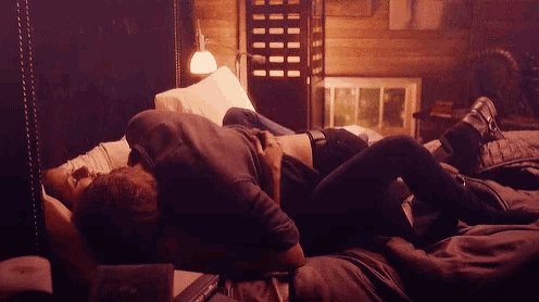 a man and a woman are laying on a bed