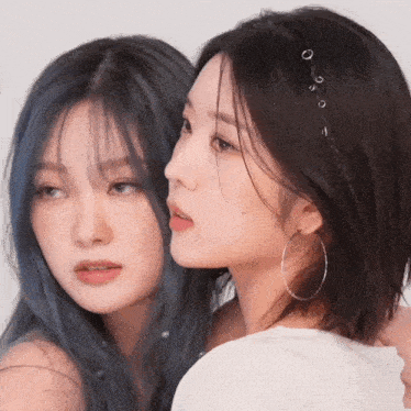 a close up of two girls with hoop earrings