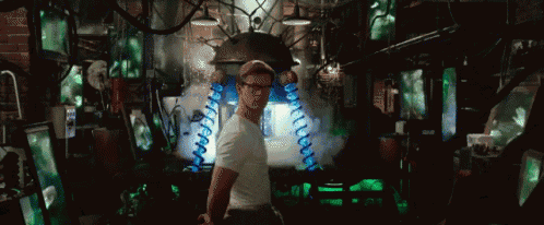 a man in a white shirt and glasses is standing in a room with a lot of green lights