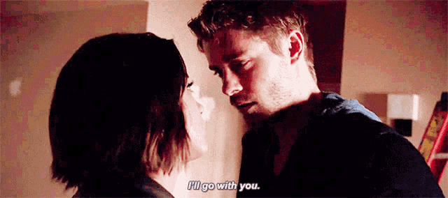 a man and a woman are looking at each other and talking .