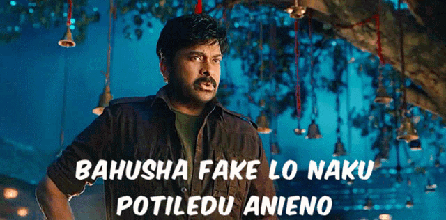a man is standing in front of a tree with bells hanging from it and the words bahusha fake lo naku potiledu anieno